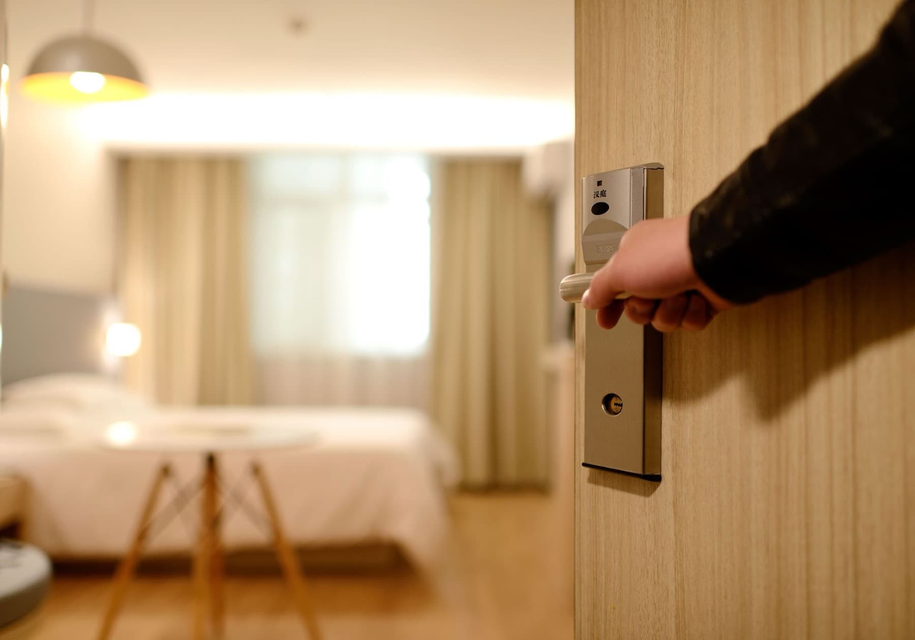 A hotel room door opening onto the room